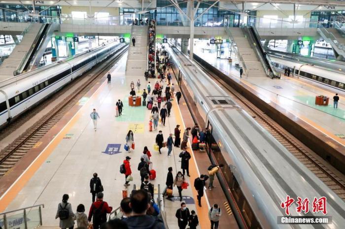 资料图：4月5日，旅客在武汉火车站站台准备乘坐高铁列车。 图片来源：视觉中国