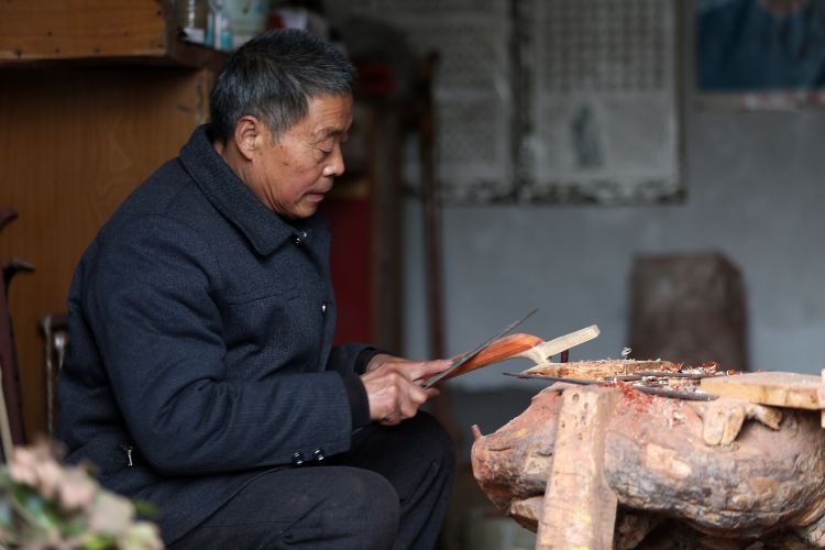 1月8日,乐泉村村民高振保在制作二胡琴杆.